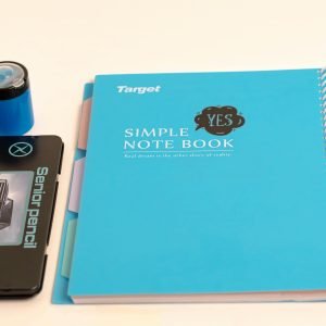 Flat lay of school supplies including notebook, pencils, and ruler on white background.