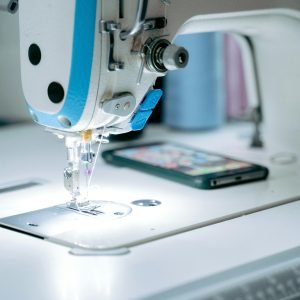 Focused view of an industrial sewing machine with attention to detail, ideal for tailoring themes.